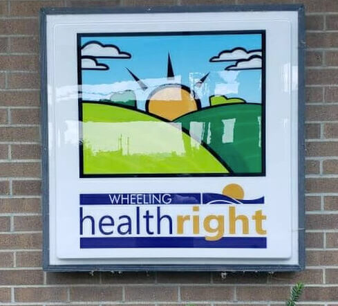 Wheeling Health Right sign on a brick building